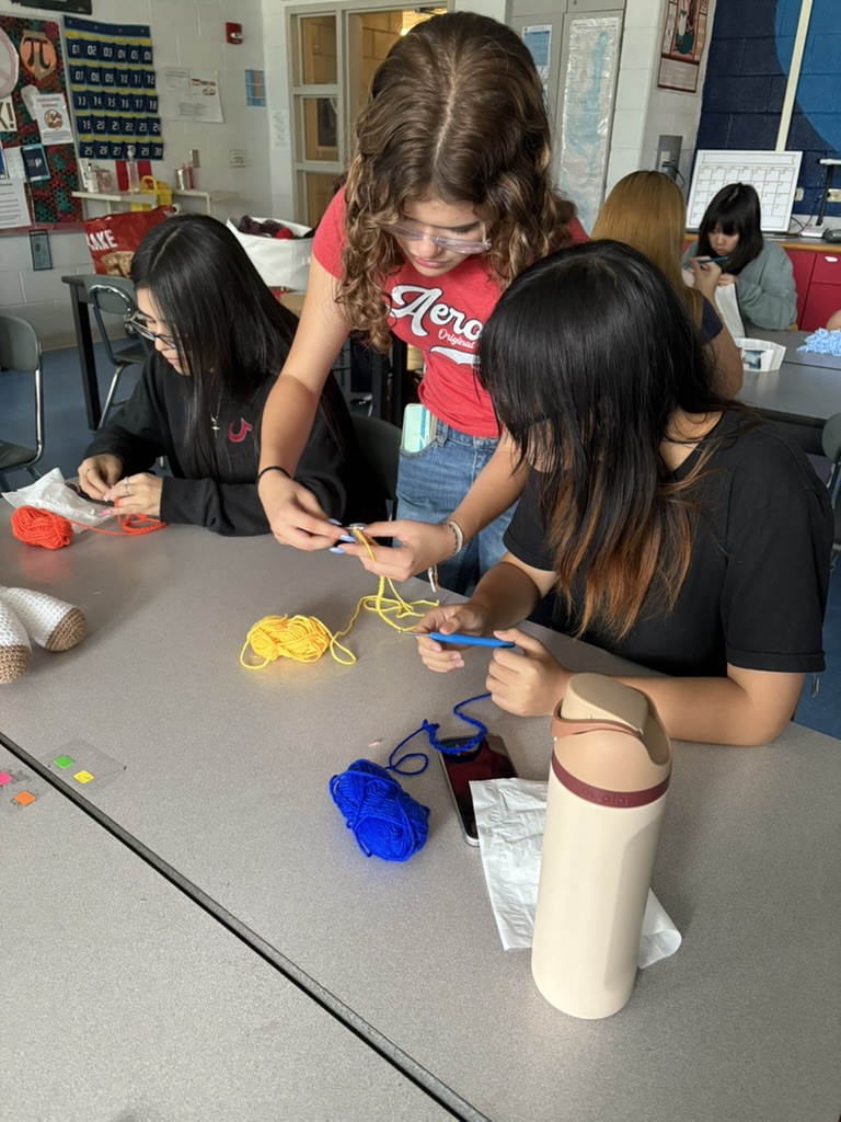 Students crocheting together as part of the club